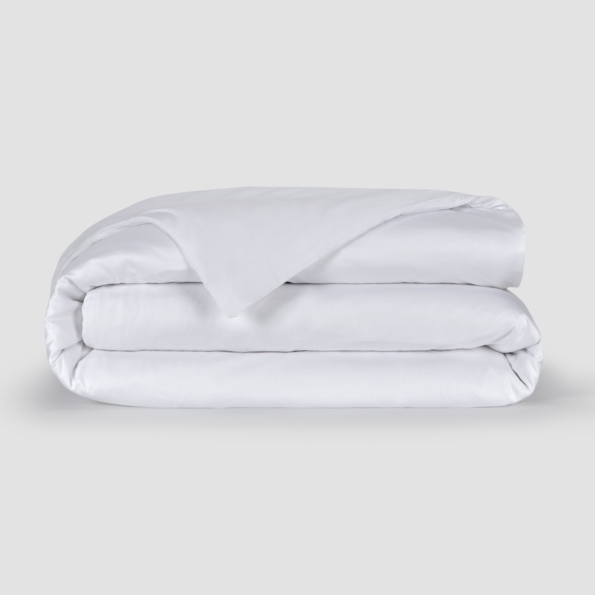 White folded duvet cover showcasing soft 100% bamboo fabric texture with hidden buttons at the bottom