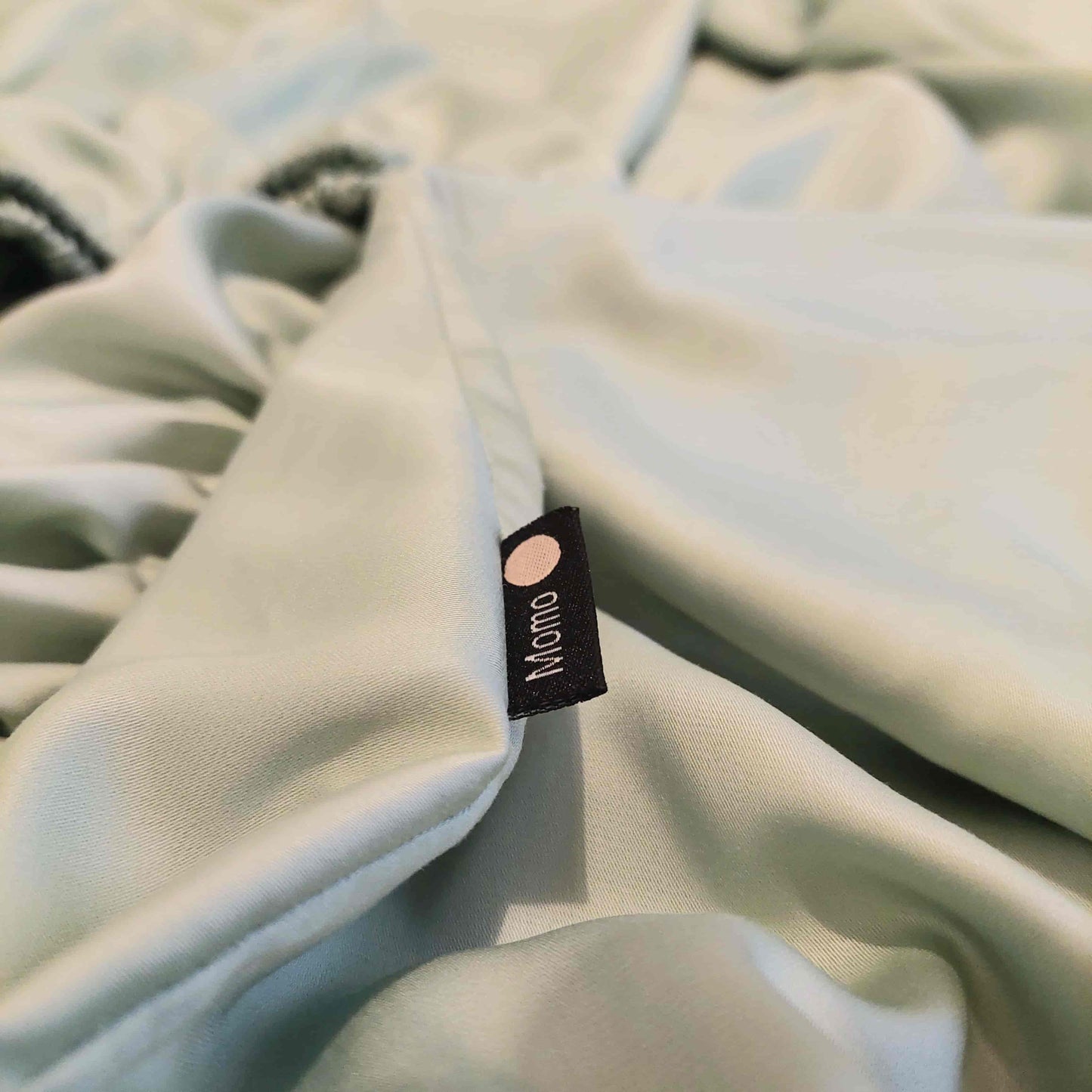 Close-up of label on green bamboo sheet – soft, breathable and sustainable bedding
