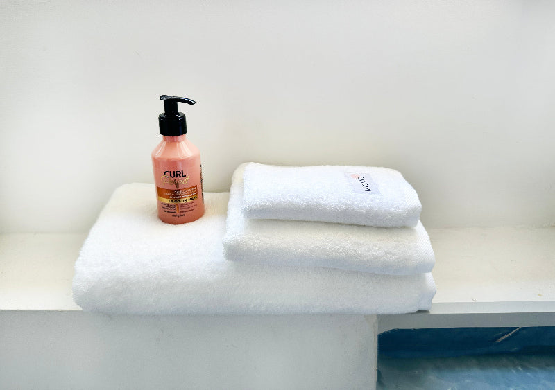 Three-piece white bamboo towel set with bottle – bath, hand and face towels, soft, absorbent and sustainable