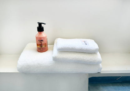Three-piece white bamboo towel set with bottle – bath, hand and face towels, soft, absorbent and sustainable