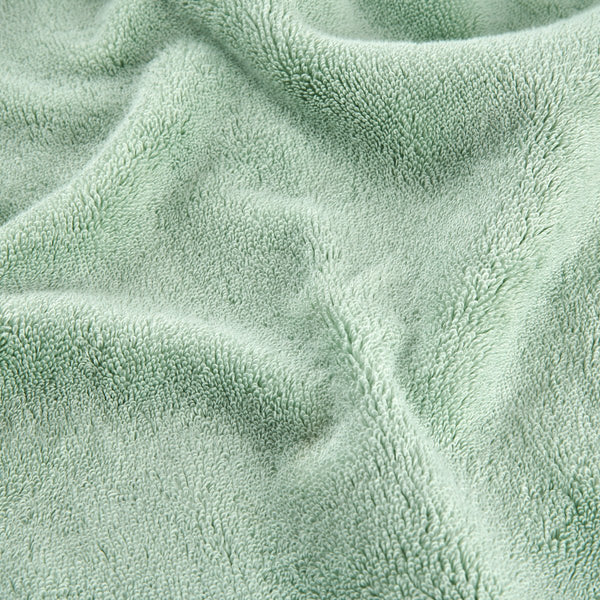Ensemble de serviettes en bambou vert montrant la texture douce du tissu en vue rapprochée