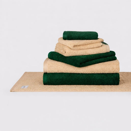 Momo Cotton Wabi Sabi towel set stacked in cream and forest green on white background