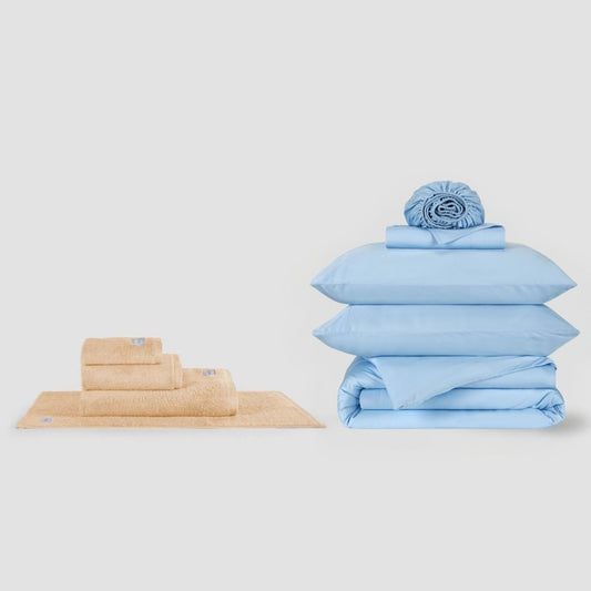 Beige towel set and blue bedsheet set stacked side by side, Momo Cotton collection