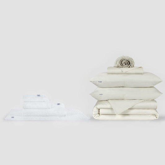 Momo Cotton complete sheet set and towel collection displayed in cream, showing folded bedding and towels on white background