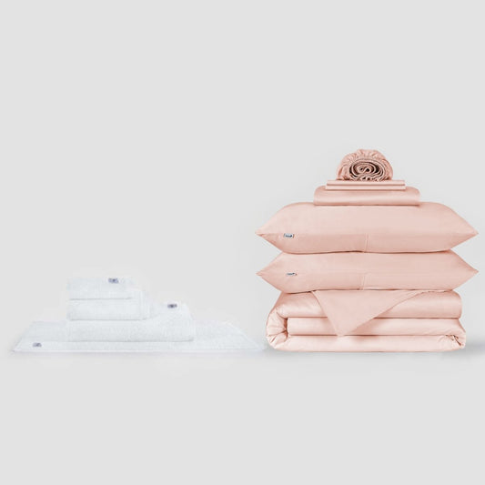 White towel set and pink bed linen set with decorative pillow displayed against neutral background by Momo Cotton