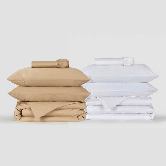 Beige and white bedding sets stacked neatly, featuring pillows and duvet covers by Momo Cotton