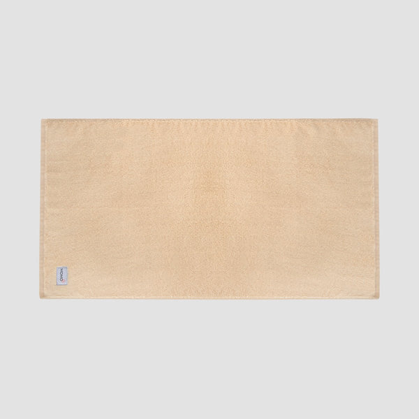 Tapis de bain beige en bambou Momo Cotton – doux, absorbant, séchage rapide et durable.